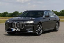 2025 BMW 7 Series luxury sedan in a modern city background.