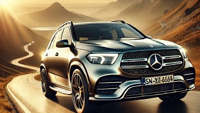 2025 Mercedes-Benz GLE-Class driving on a mountain road at sunset.